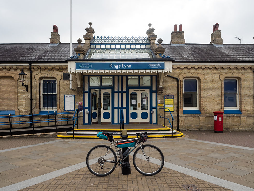 Bicycle leaning on bollard out the front of King's Lynn Railway Station.