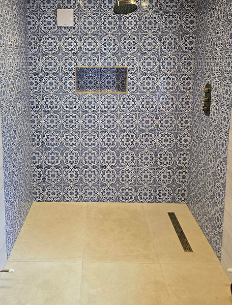 Patterned bathroom wall and limestone floor tiling in Rossendale