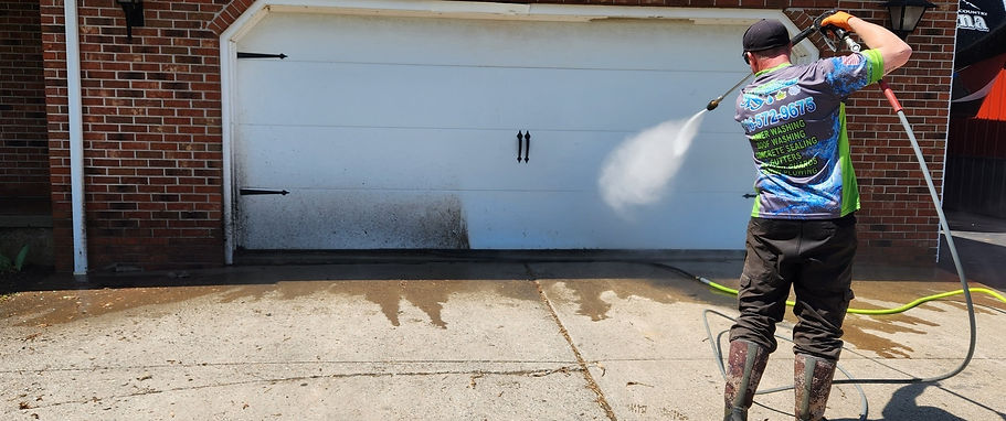 steady kenny services pressure washing a garage door on a home in amherst ny