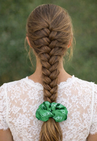 Braided hair with a green Lucky hair scrunchie