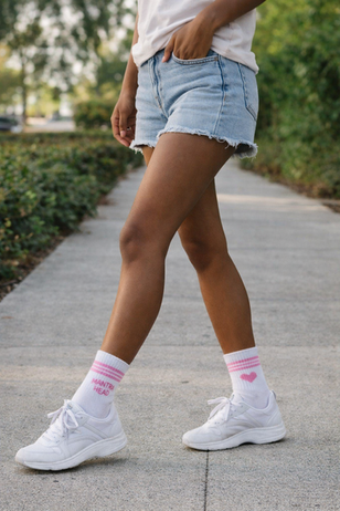 Love Always hearts mantra socks from Mantra Head on a woman walking.  