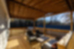 Covered back porch with gas grill and seating