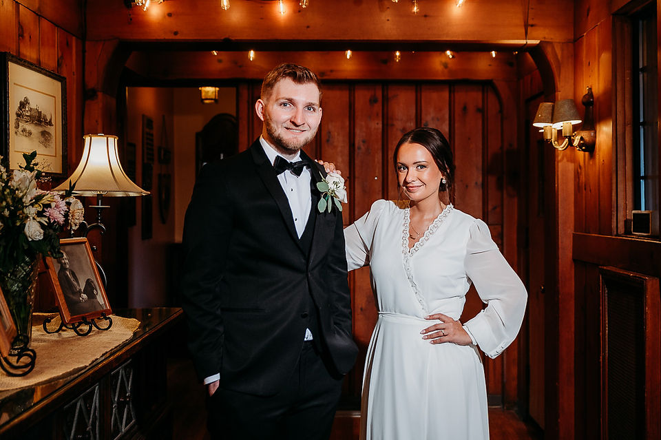 three-quarter length portrait of bride and groom in the entryway at Cascades Manor
