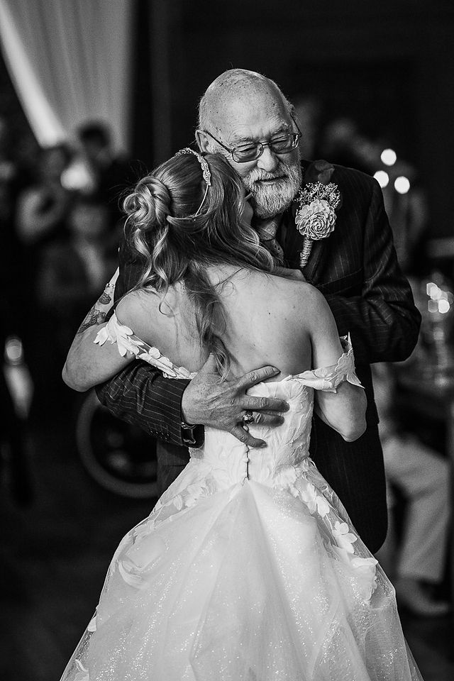 bride and grandpa hugging during first dance
