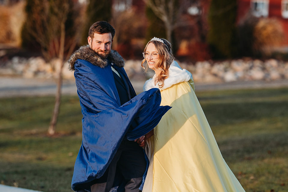 bride and groom wearing capes like the ones from the movie Beauty and the Beast