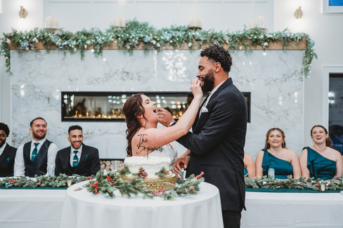 bride and groom feeding each other cake