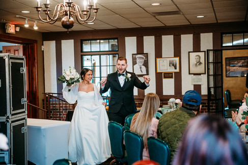 bride and groom cheering as they enter their reception at Cascades Manor