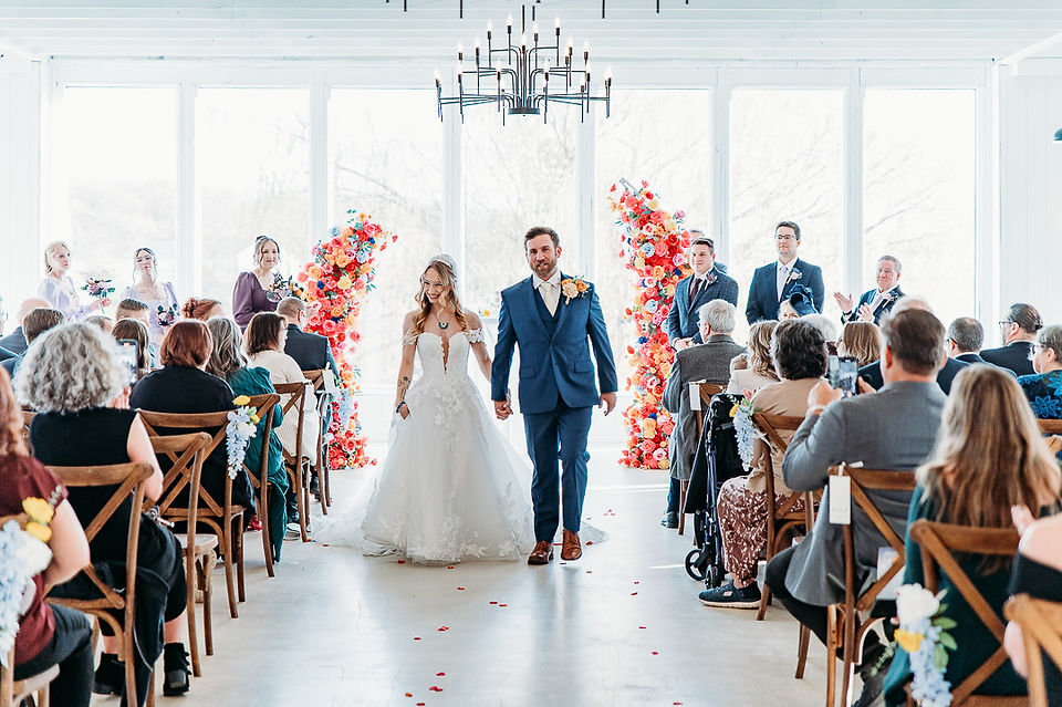 bride and groom walking down the aisle during the processional