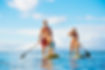 Family Having Fun Stand Up Paddling Together in the Ocean on Beautiful Sunny Morning.jpg