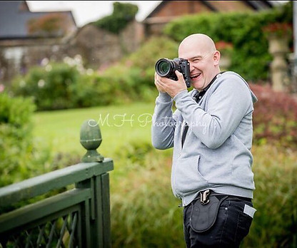 Wedding photographer Marcus Horwood capturing a bride and groom during an outdoor wedding photoshoot at Parley Manor