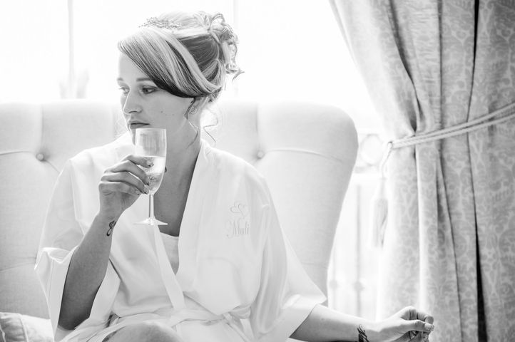 Bride drinking champagne during wedding morning preparations in Bournemouth