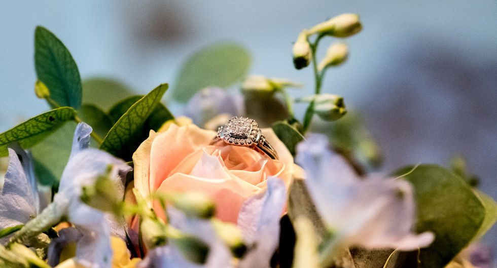 Bride’s diamond engagement ring on wedding bouquet at Parley Manor