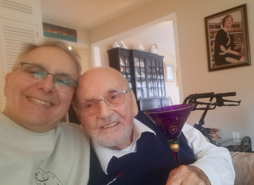 Author and his father with a portrait of his late mom in the background