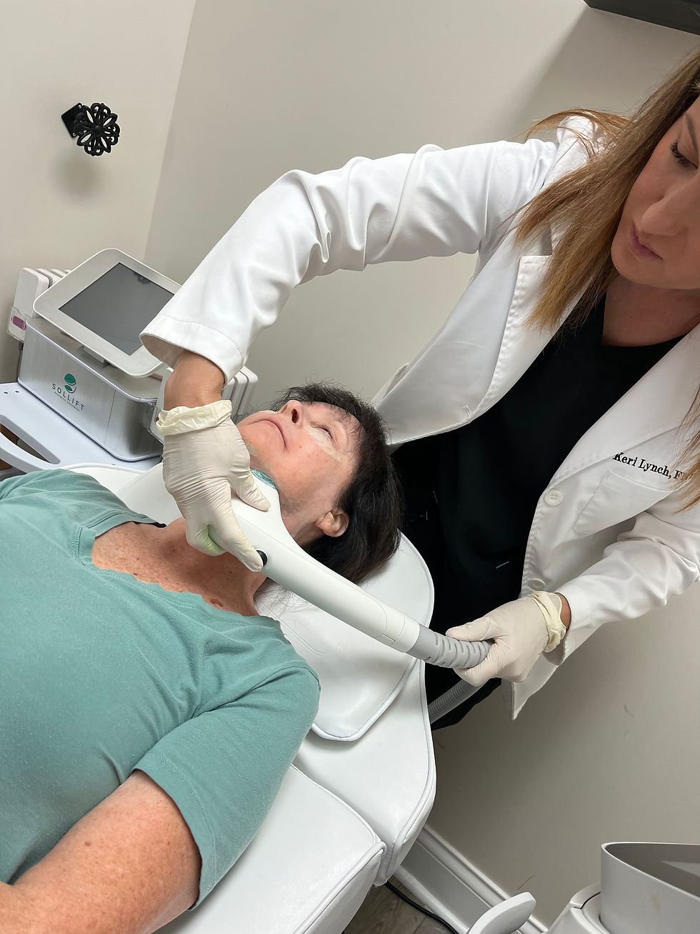 Eye-level view of a modern treatment room with a Sofwave device