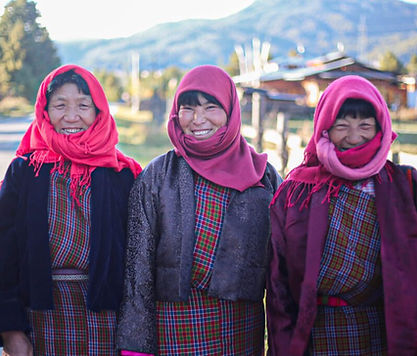 Friendly local people of Bumthang dressed in traditional Bhutanese attire, engaging in daily village life
