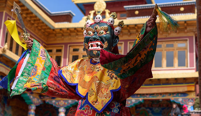 Traditional Bhutanese houses nestled in the scenic Ura Village surrounded by rolling hills and lush greenery