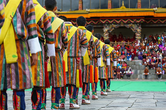 Performers in colorful attire showcasing a traditional cultural dance during a festive celebration