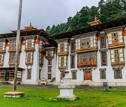 Kurjey Lhakhang monastery complex surrounded by lush greenery, a sacred pilgrimage site in Bumthang, Bhutan