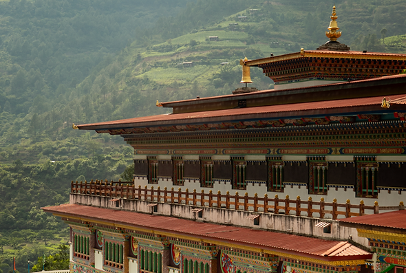 Traditional Bhutanese monastery with ornate architecture nestled in a serene mountain landscape