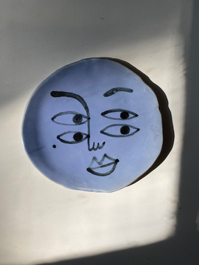 Ceramic plate with the painted face with signature style of an artist Kristina Supernova.