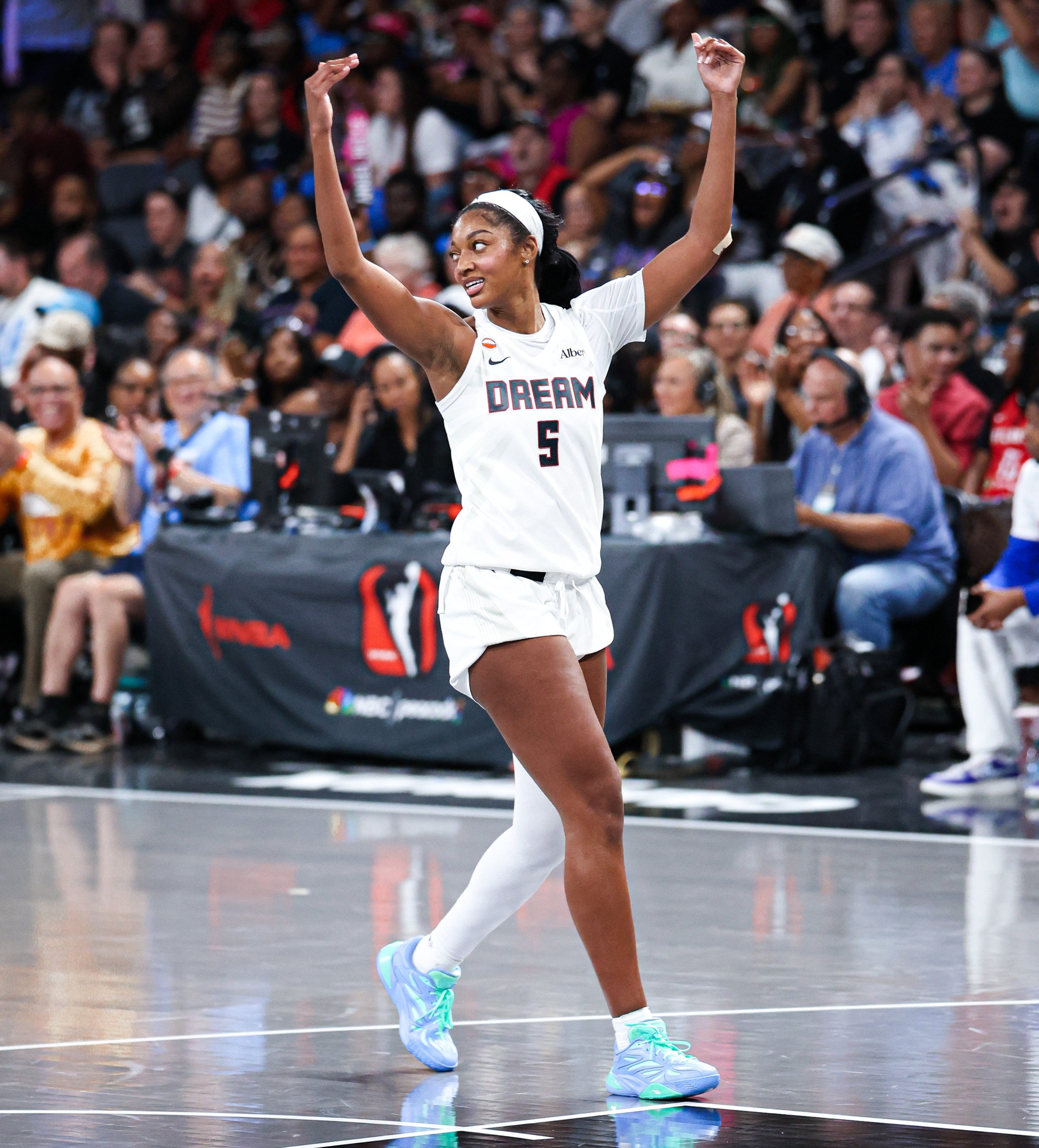 Angel Reese celebrating and pumping the crowd.
