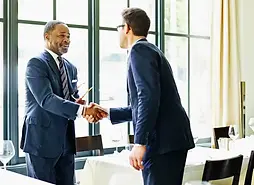 Young father shaking hands with a professional mentor, symbolizing career support and oppo