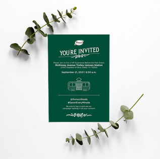 Green invitation card titled You're Invited with eucalyptus branches