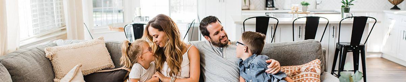 Family relaxing on the sofa and enjoying a clean home with the House and Apartment Cleaning service