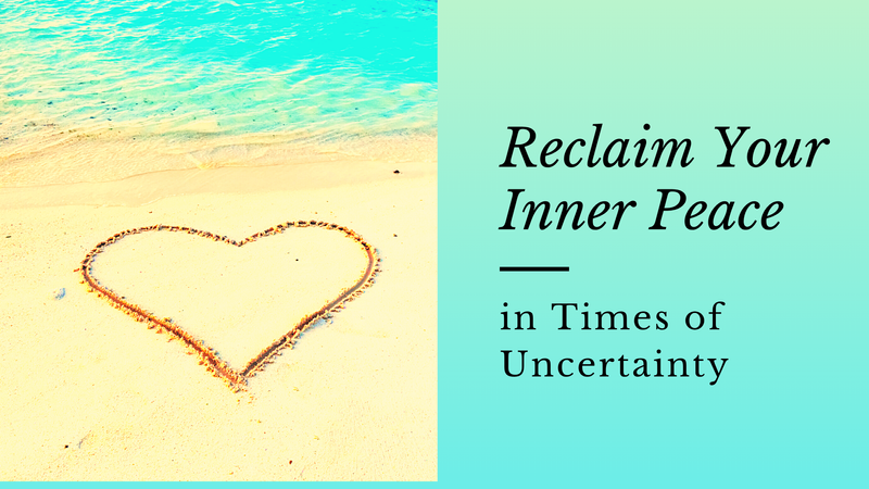 A heart shape drawn in the sand on a beach with a wave rolling out behind it. 