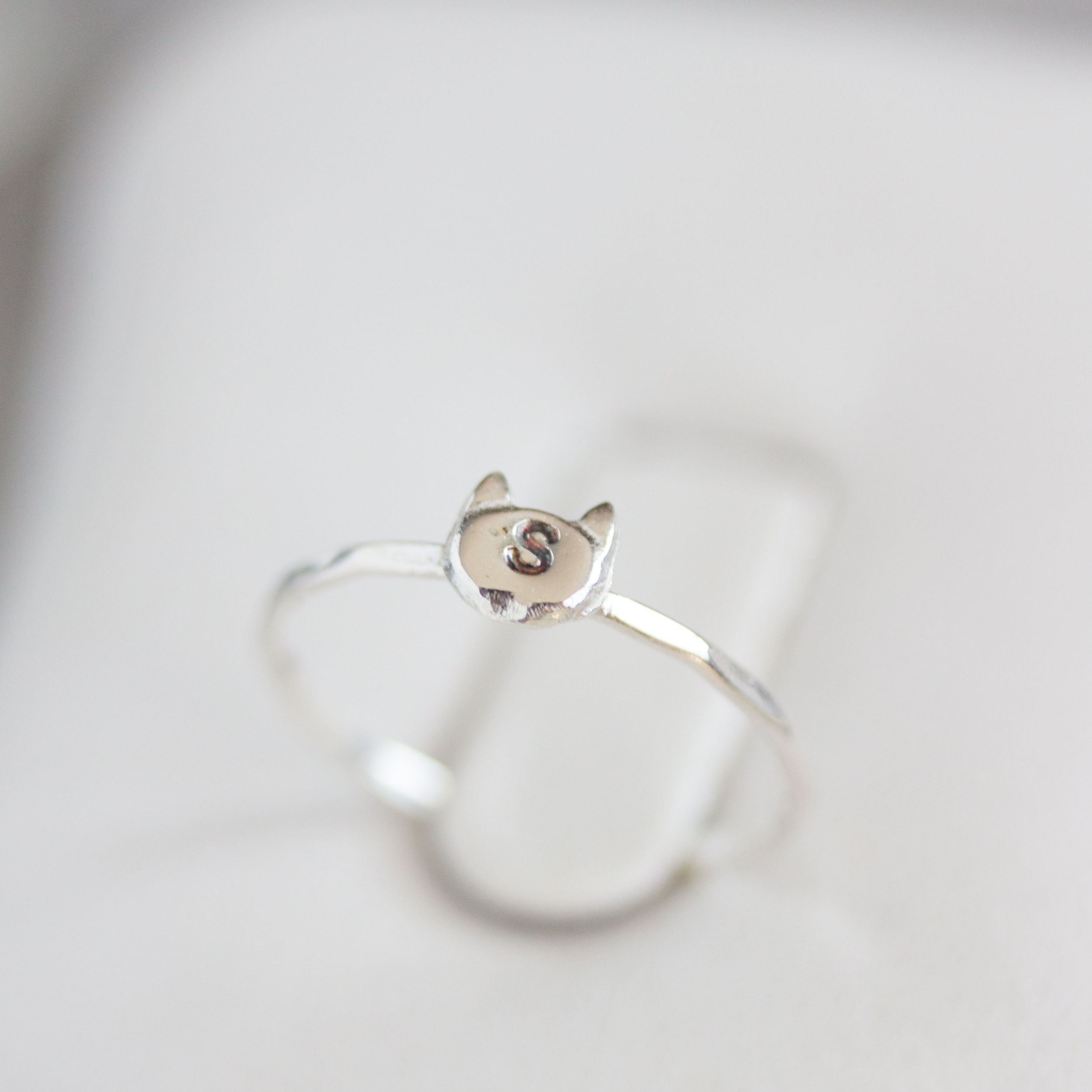 Initial ring with hand stamping in a cat head shape