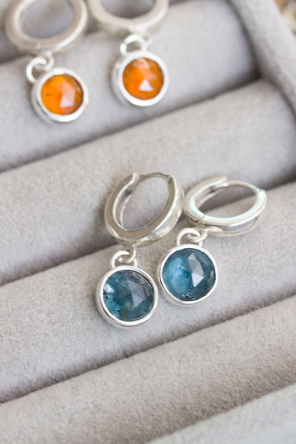 Thumbnail: Huggie earrings with dangling blue kyanites in sterling silver