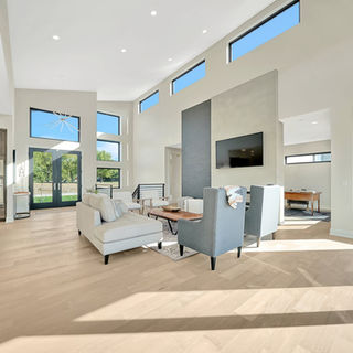 Murray Custom Homes designed living room with high ceilings, modern finishes, and tall windows for natural light