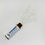 Miniatura: Homeopathic vial tipped on side with white pellets spilled across surface and label clearly visible.