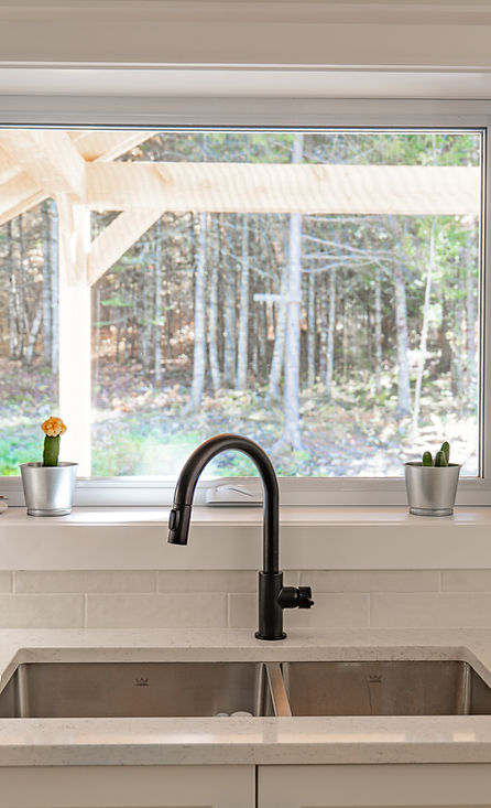 Modern kitchen renovation with natural light and quality fixtures by IJM Builders Fredericton