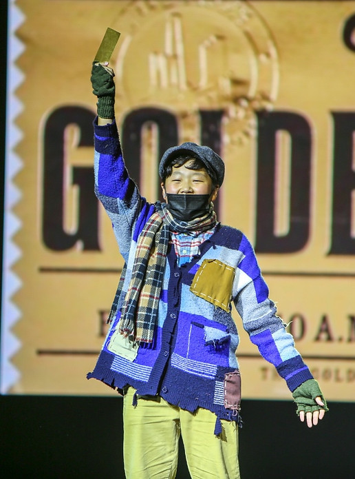 This is the picture of Charlie holding the Golden Ticket for touring Willy Wonka's chocolate factory!
