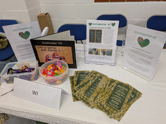 Leaflets and sweets displayed on a table to promote the local Women's Institution.
