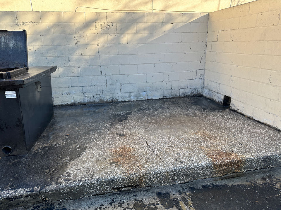 Freshly cleaned dumpster pad.