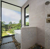 Expansive bathroom with a luxurious soaking tub and stunning views. Immerse yourself in a peaceful, spa-style escape ideal for unwinding in true Costa Rica comfort.