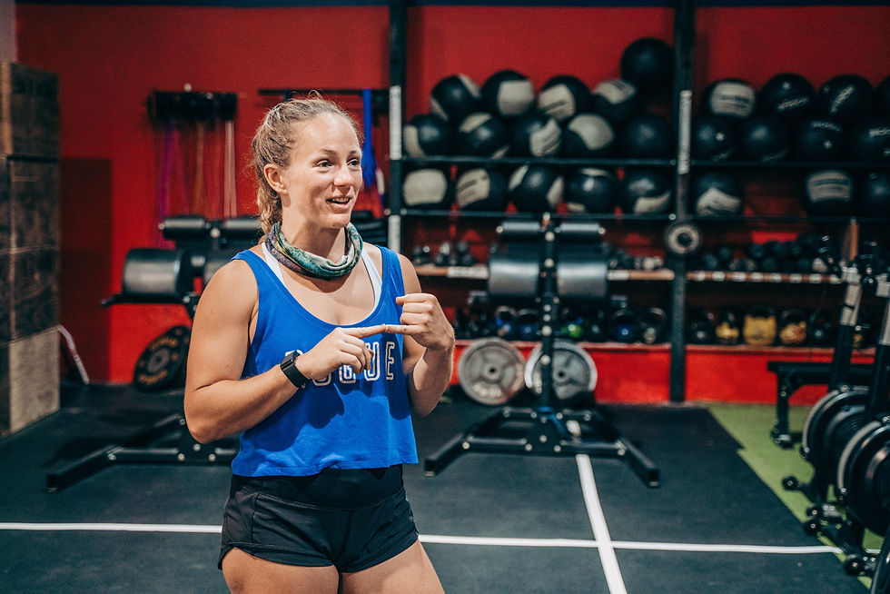 Coach Nicole mid- explanation to her client what the next exercise is.