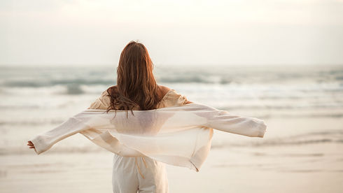 Happy young asian woman with freedom on the sea beach at golden sunset, Summer beach vacat