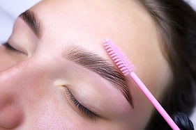 combing-the-hairs-in-the-eyebrows-with-a-brush-after-the-procedure-of-coloring-and-laminat