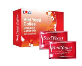 Close-up view of a cup of Edmark Red Yeast Coffee with coffee beans on a wooden table