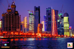 Night view of skyline along waterfront of Corniche