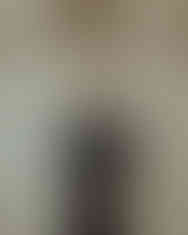 Man in black t-shirt with "COUTURE" text, posing against a neutral background.