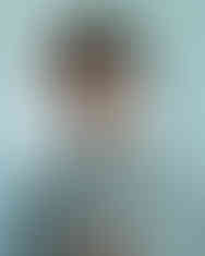 Woman with brown hair wearing sunglasses and a bear t-shirt LUXR fashion.