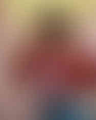 Woman wearing red shirt with alpaca design and heart-shaped sunglasses, LUXR.