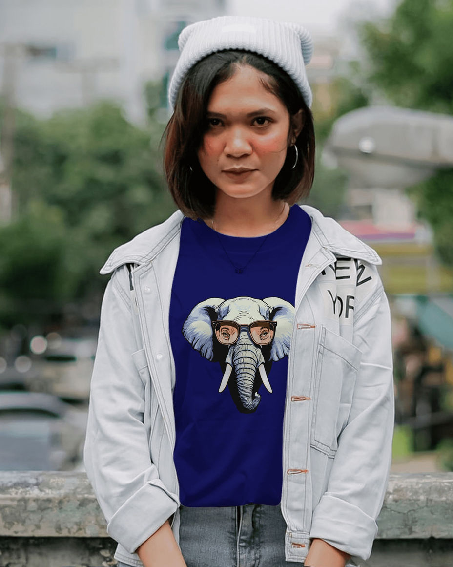 Woman wearing glasses with elephant graphic on blue shirt and LUXR.