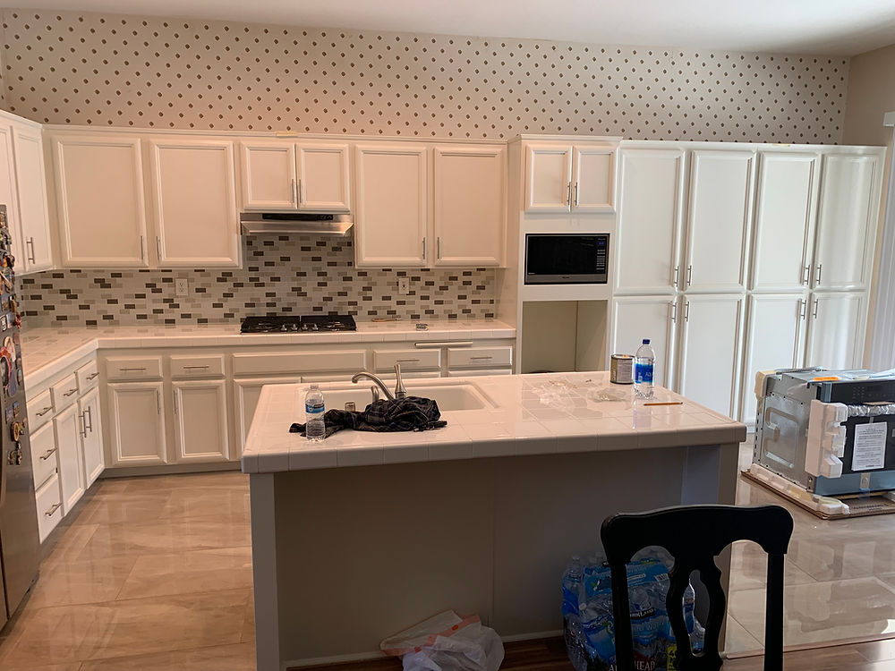 Completed kitchen project with white cabinets and island; kitchen-cabinet-refacing-vista