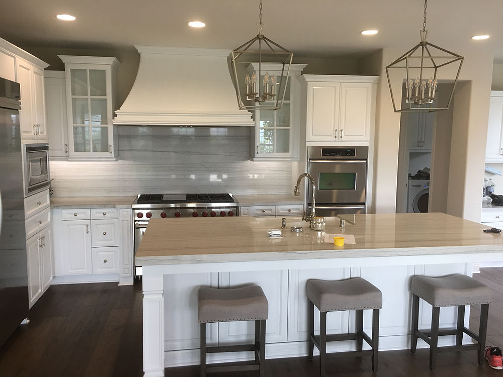 Completed kitchen project with white cabinets and island