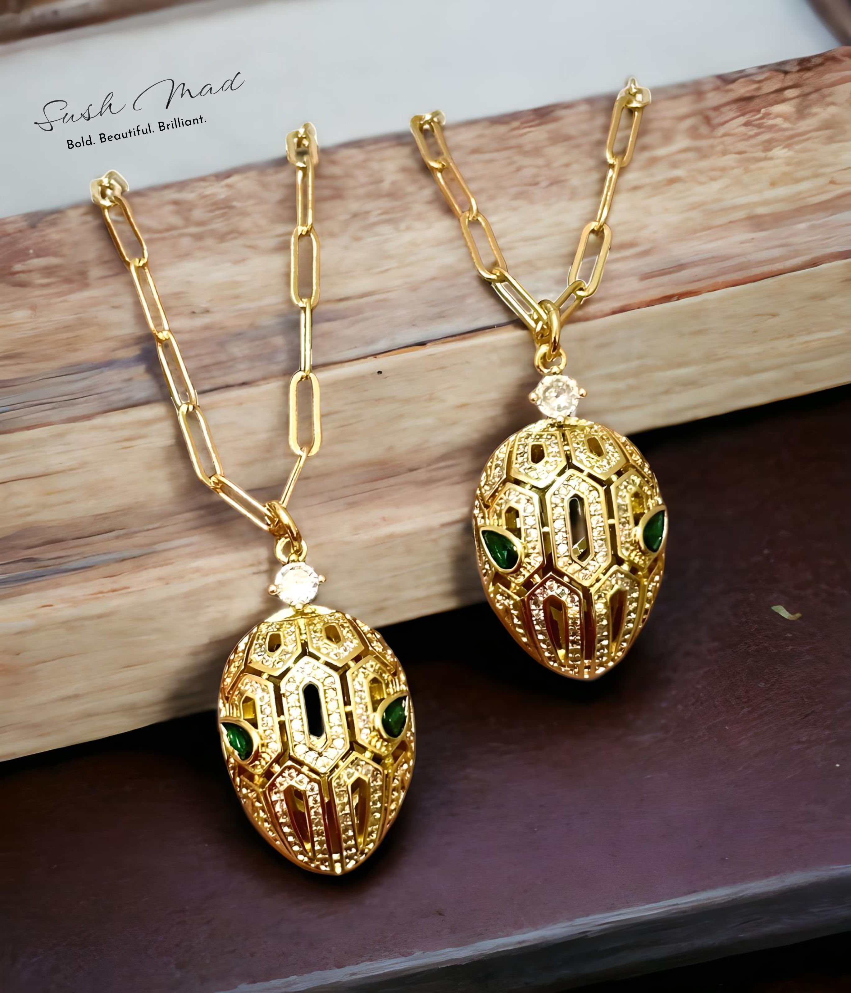 Displaying Sush Mad's Golden Serpent Duo Pendants